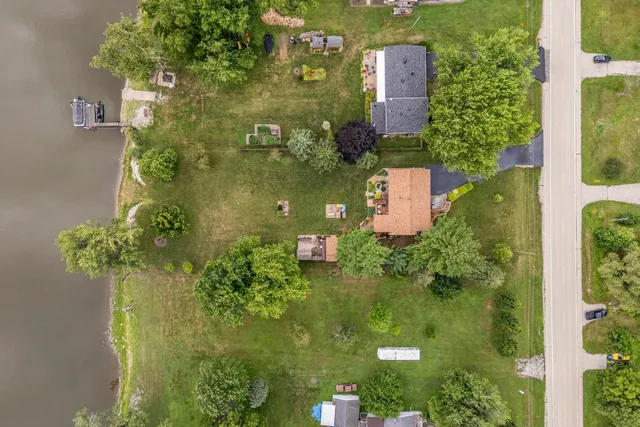 an aerial view of a house with a yard