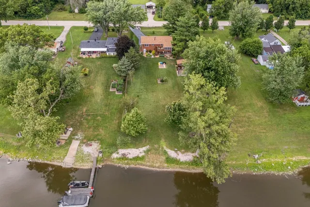 a aerial view of a house with a yard basket ball court and outdoor seating