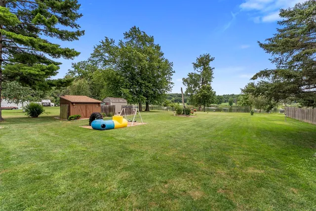 a view of a house with a backyard