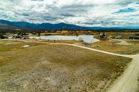 a view of a yard with snow on the road