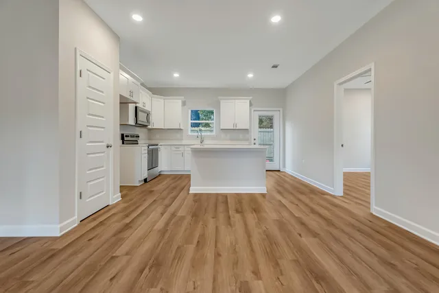 a kitchen with wooden floors and appliances
