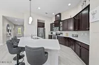 a kitchen with stainless steel appliances kitchen island a sink stove and refrigerator