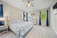 a living room with a bed furniture and a flat screen tv