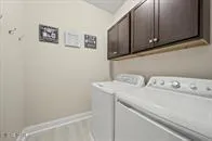 a view of a living room and floor to ceiling window and an outdoor seating