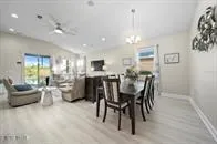 a view of a dining room with furniture and chandelier