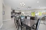 a view of a dining room with furniture and chandelier