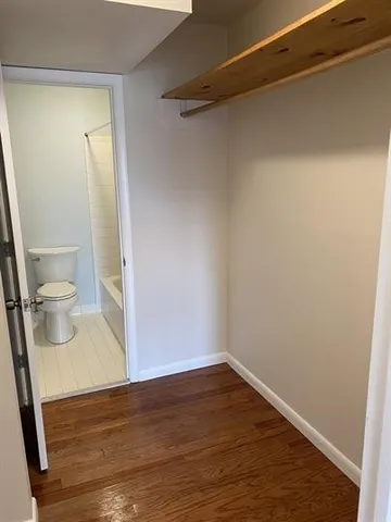 a view of a room with wooden floor and a sink