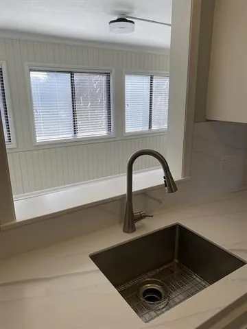 a bathroom with a sink and a window