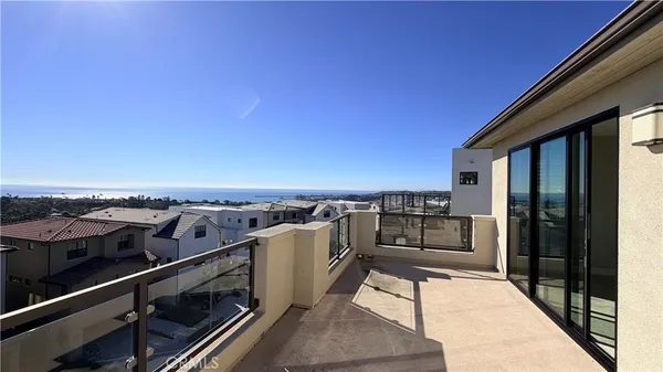 a view of a balcony with an outdoor seating