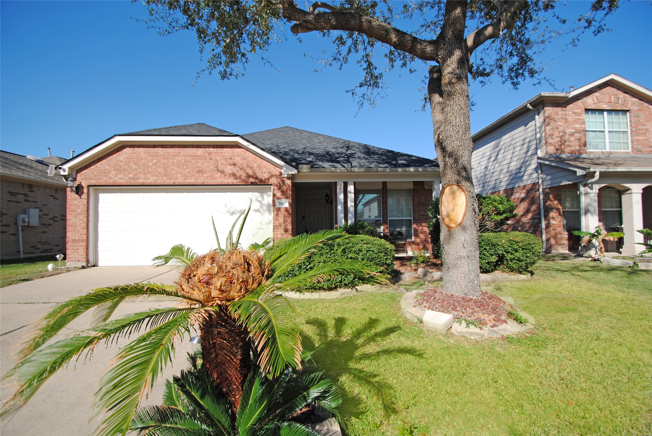 a front view of a house with a garden