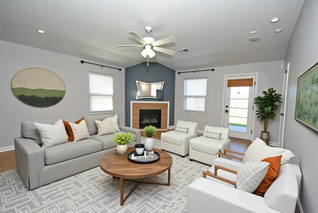 a living room with furniture a rug and a fireplace