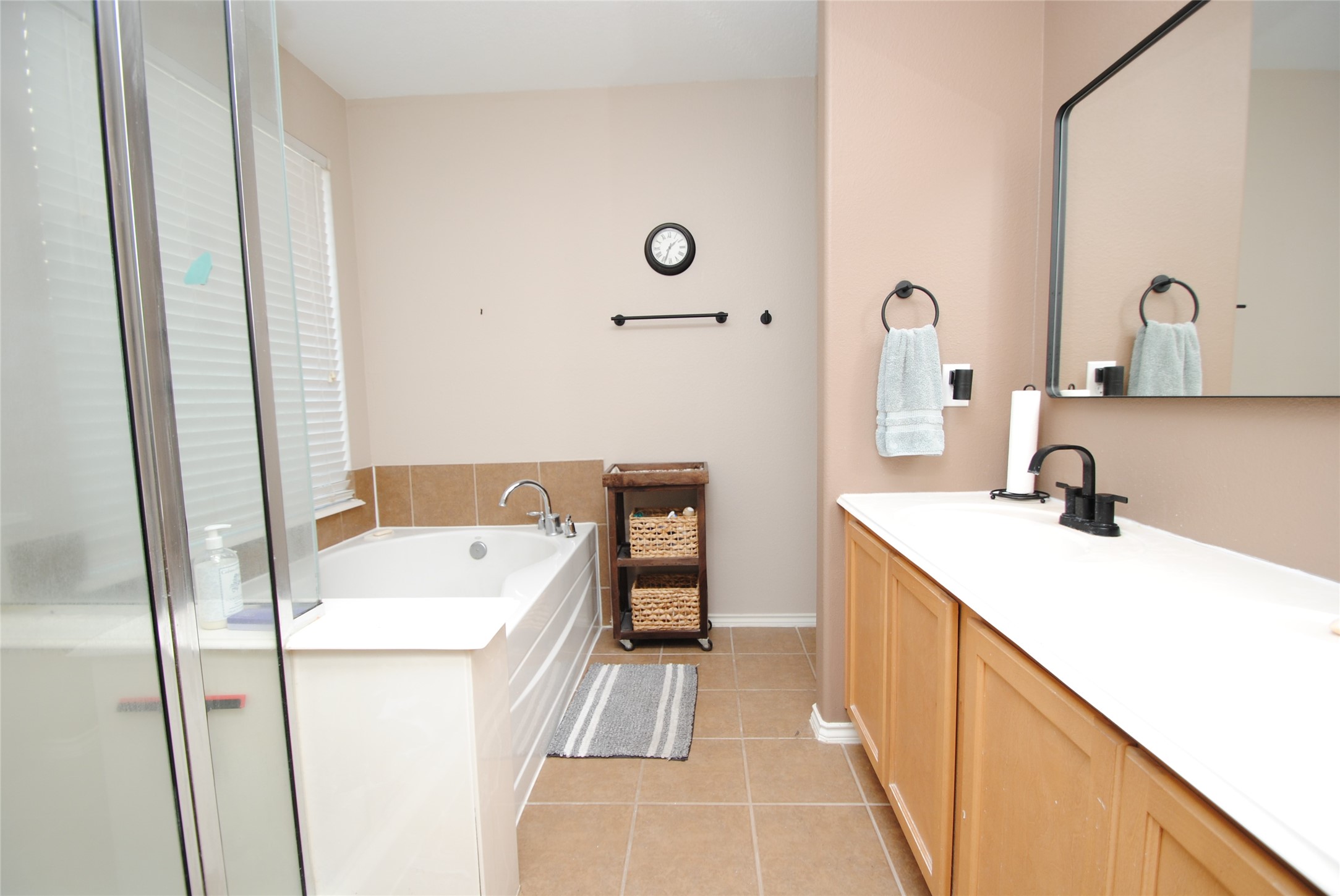 16427 Kettlebrook Lane Houston, TX 77049 - Photo 16 of 27 a bathroom with a sink and a mirror
