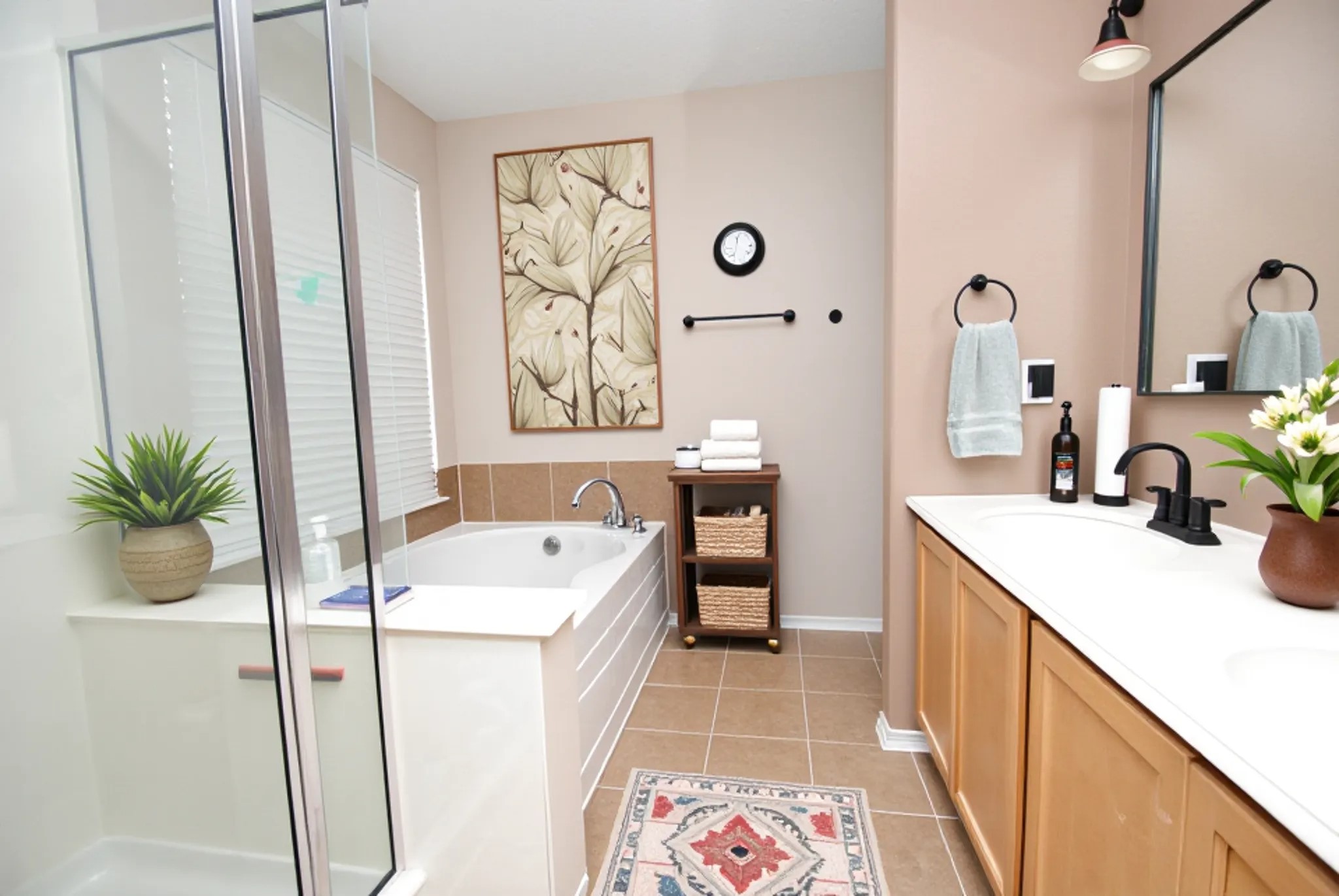 16427 Kettlebrook Lane Houston, TX 77049 - Photo 17 of 27 a bathroom with a sink a tub and a mirror