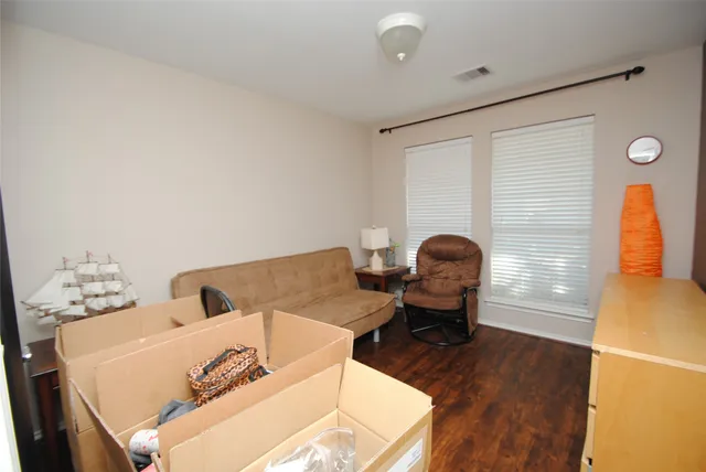 a living room with furniture and wooden floor
