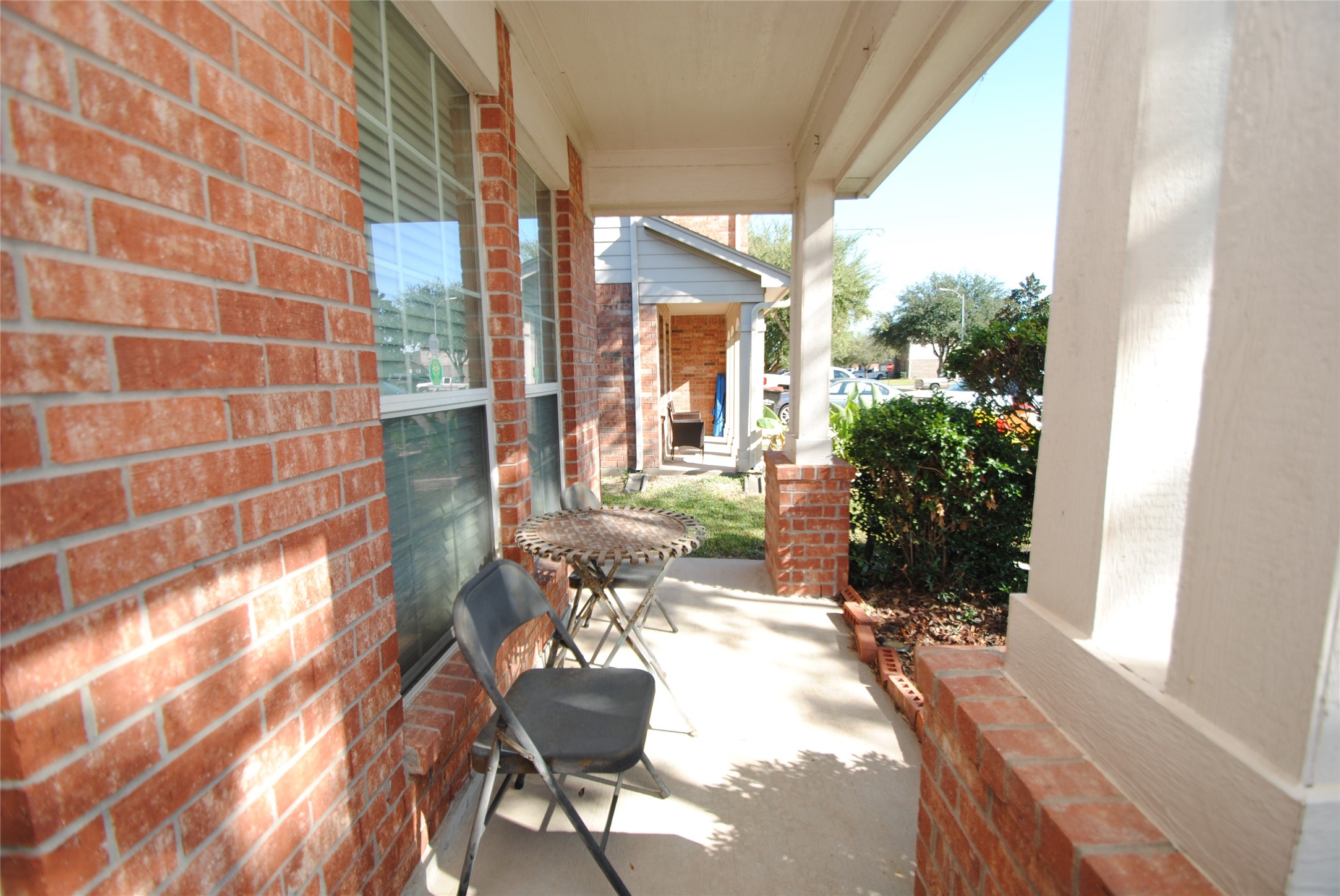 16427 Kettlebrook Lane Houston, TX 77049 - Photo 2 of 27 a porch with a bench and chairs