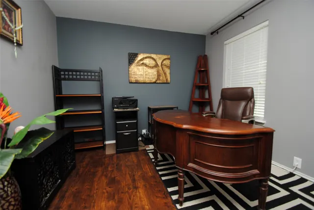 a room with chairs and a bookshelf