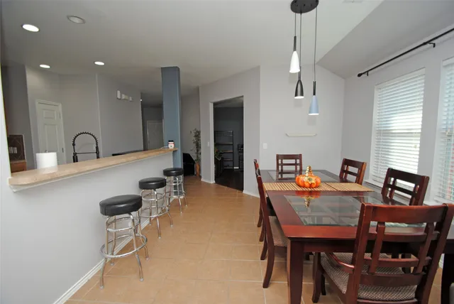 a dining room with furniture and window