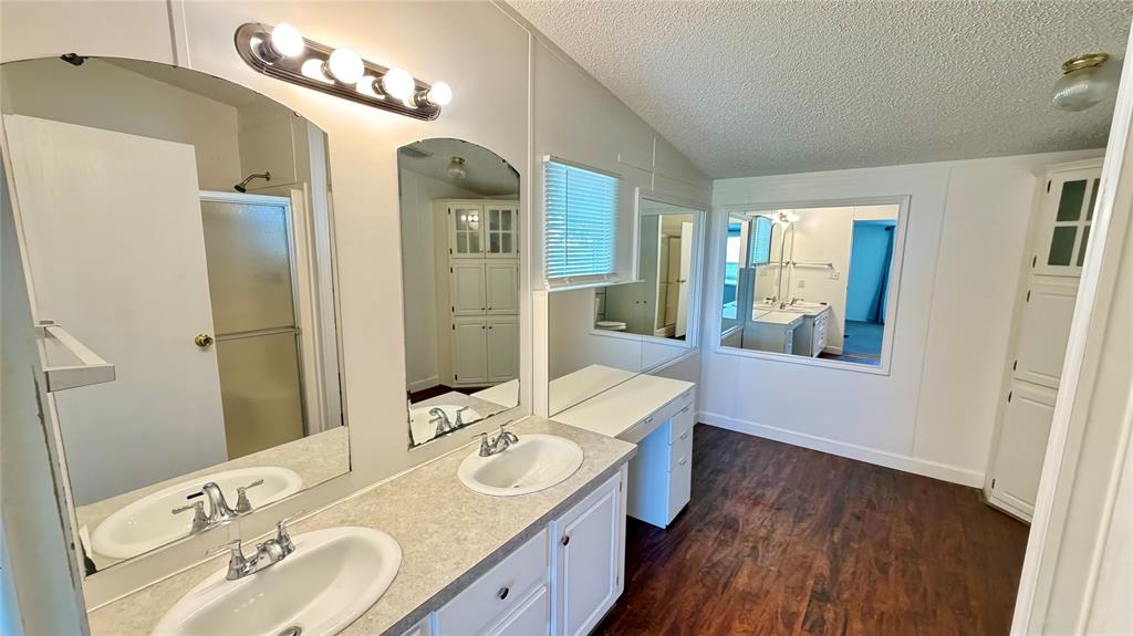 3789 Jacobs Lane Kaufman, TX 75142 - Photo 18 of 33 a en suite bathroom with a double vanity sink a mirror and a shower