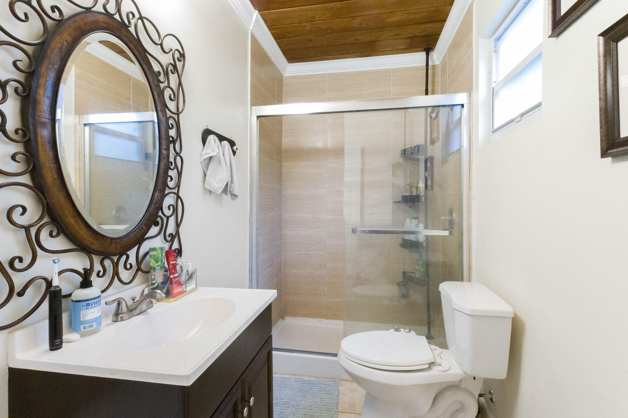 614 North 7th Street, Unit 1/2 Lantana, FL 33462 - Photo 14 of 18 a bathroom with a sink a mirror a toilet and a shower