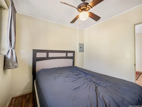 a bed sitting in a bedroom next to a bathroom