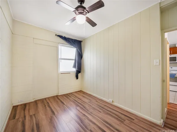 a view of a room with wooden floor and natural light