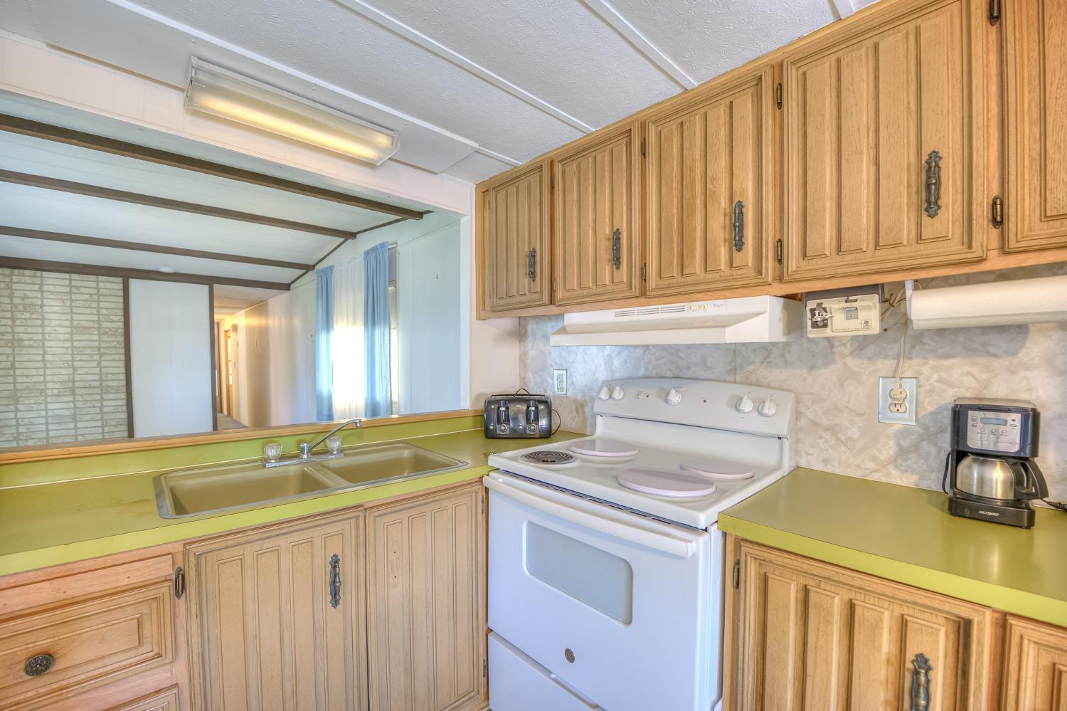 1272 Villa Avenue, Unit 24 Clovis, CA 93612 - Photo 12 of 21 a kitchen with a sink cabinets appliances and a window
