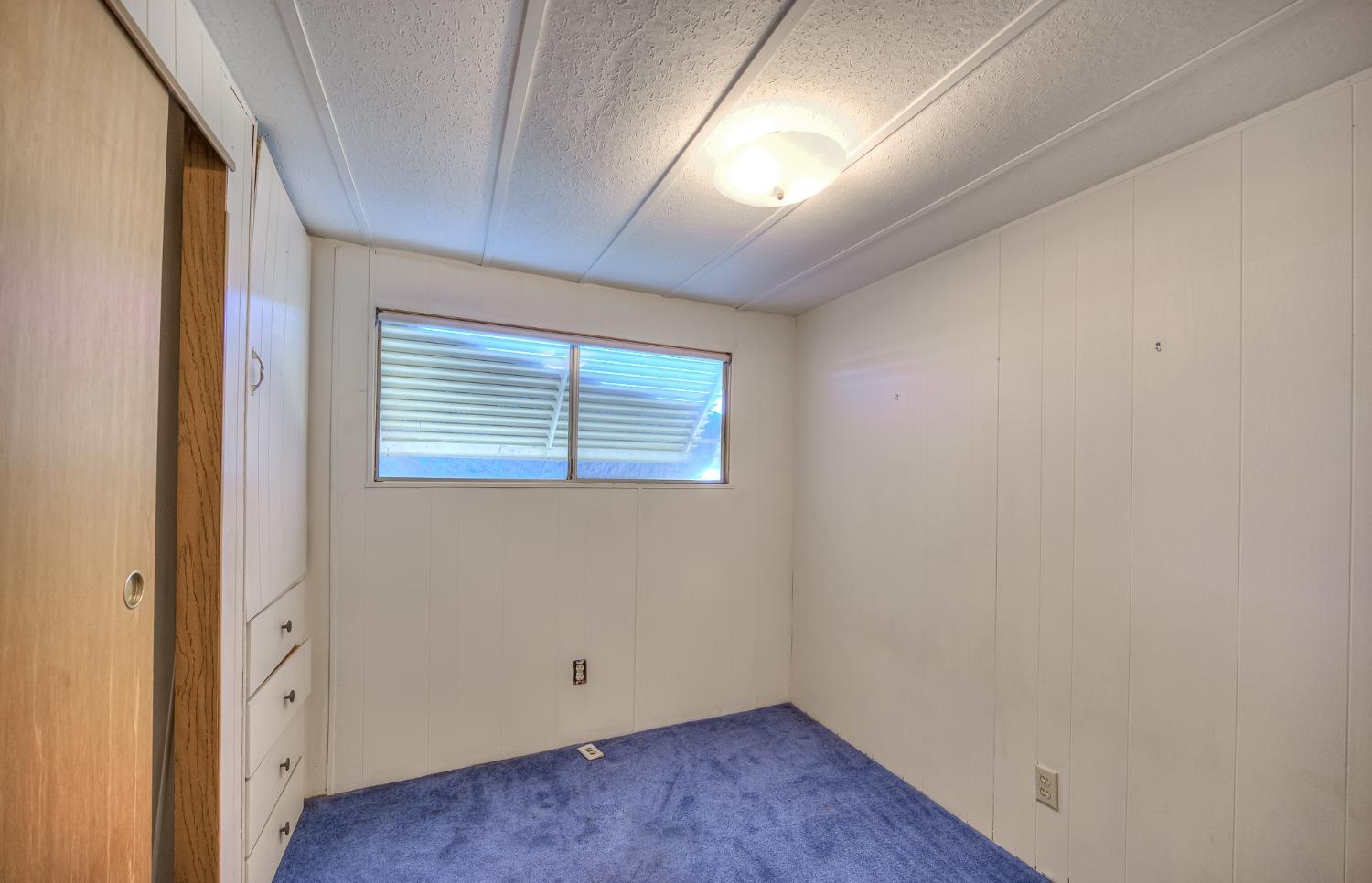 1272 Villa Avenue, Unit 24 Clovis, CA 93612 - Photo 14 of 21 an empty room with wooden floor and windows