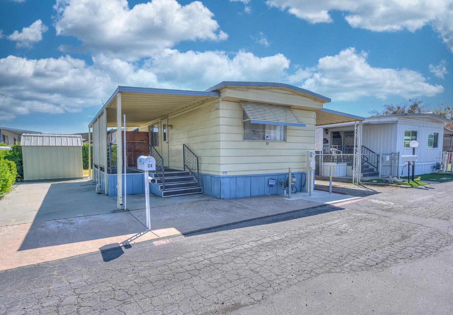 1272 Villa Avenue, Unit 24 Clovis, CA 93612 - Photo 2 of 21 a front view of a house with garden