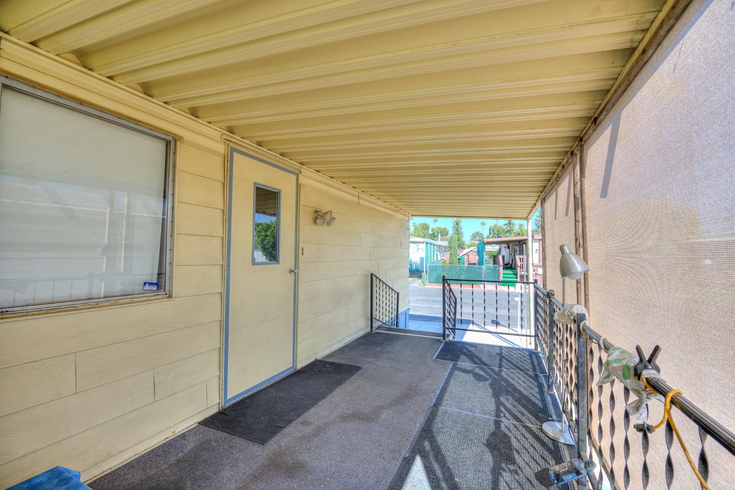 1272 Villa Avenue, Unit 24 Clovis, CA 93612 - Photo 6 of 21 a view of a porch with wooden floor and stairs