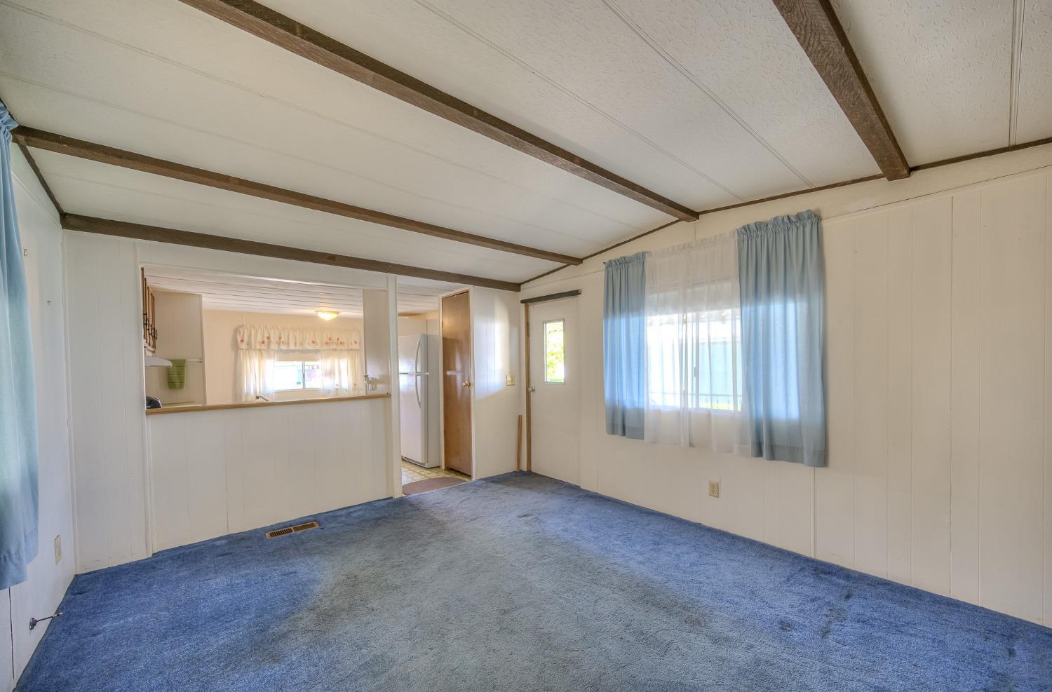 1272 Villa Avenue, Unit 24 Clovis, CA 93612 - Photo 9 of 21 a view of an empty room with wooden floor and a window