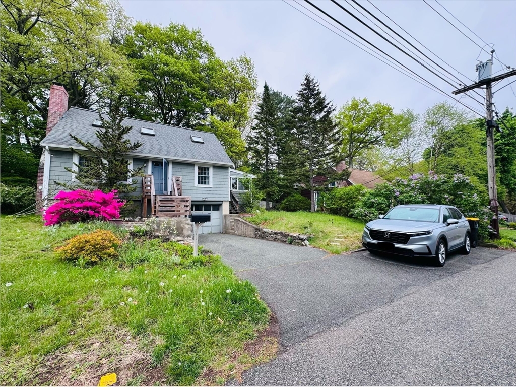 18 Lariviere Road Framingham, MA 01701 - Photo 2 of 8 a car parked in front of a house next to a yard