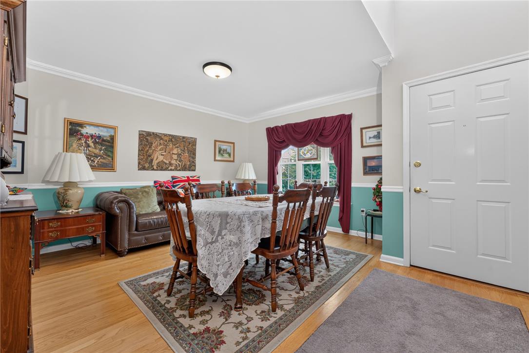 198 Park Ridge Drive Easton, PA 18040 - Photo 3 of 28 Hardwood flooring extends throughout this formal dining room, boasting crown molding and ample space for gatherings.