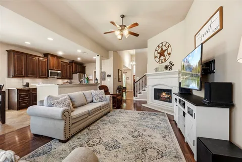 a living room with furniture a fireplace and a flat screen tv