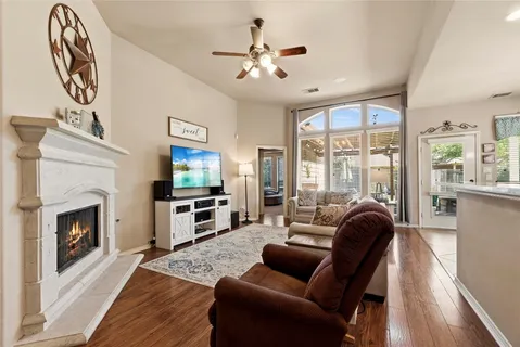 a living room with furniture fireplace and flat screen tv