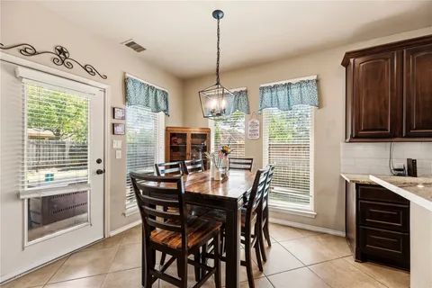 a view of a dining room with furniture window and outside view