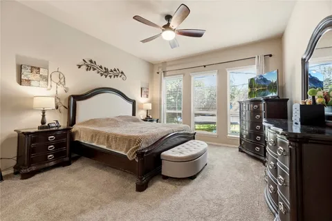 a bedroom with a bed and a tv