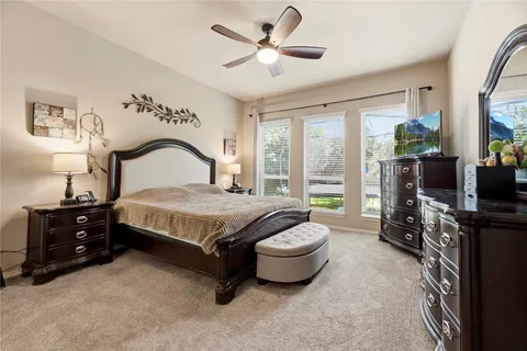 a bedroom with a bed and a tv