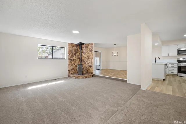 an empty room with a cabinet and a window