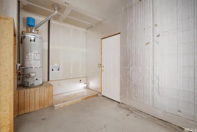 a backyard of a house with large trees and wooden fence