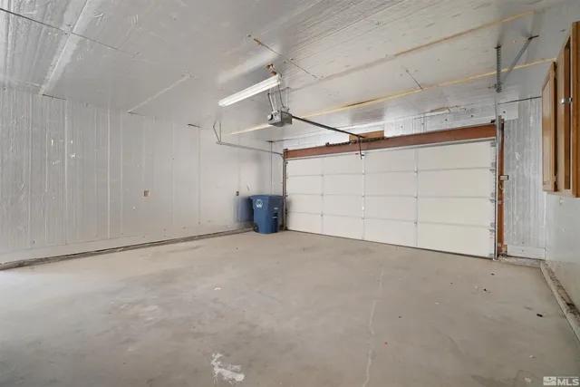 a view of a yard in front of a house with a large tree