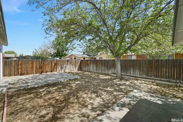 a tree in front of a white house