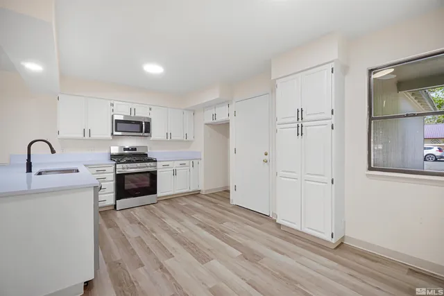 a kitchen with stainless steel appliances a refrigerator stove and sink