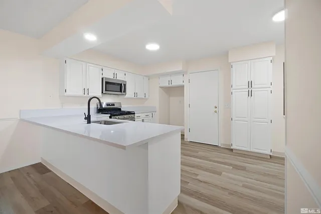 a kitchen with a sink a stove and refrigerator