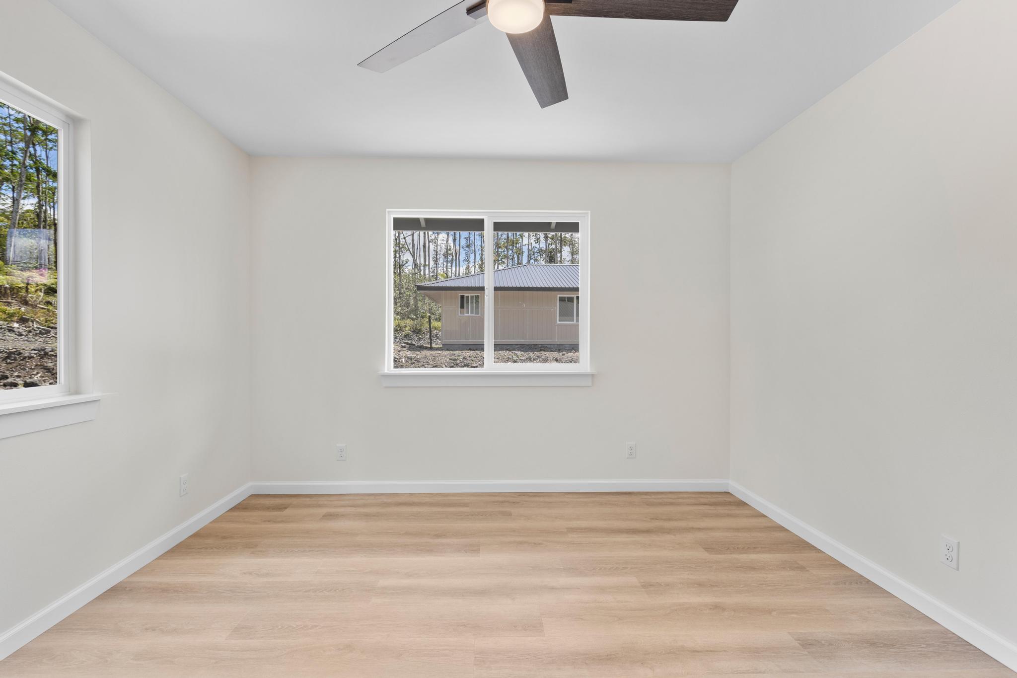 16-2579 Ainaloa Drive Pahoa, HI 96778 - Photo 11 of 30 a view of empty room with wooden floor and fan