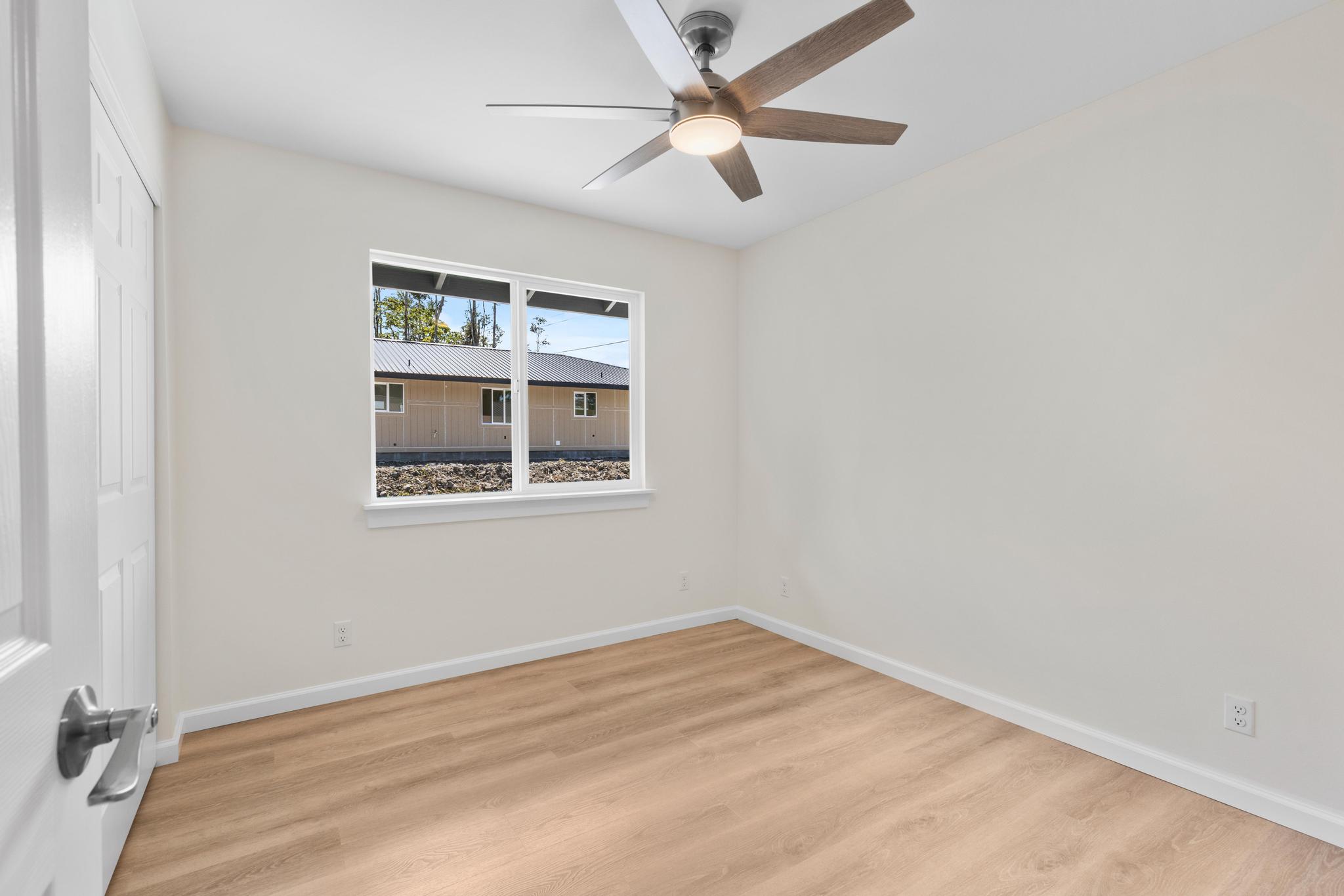 16-2579 Ainaloa Drive Pahoa, HI 96778 - Photo 14 of 30 an empty room with a window and ceiling fan