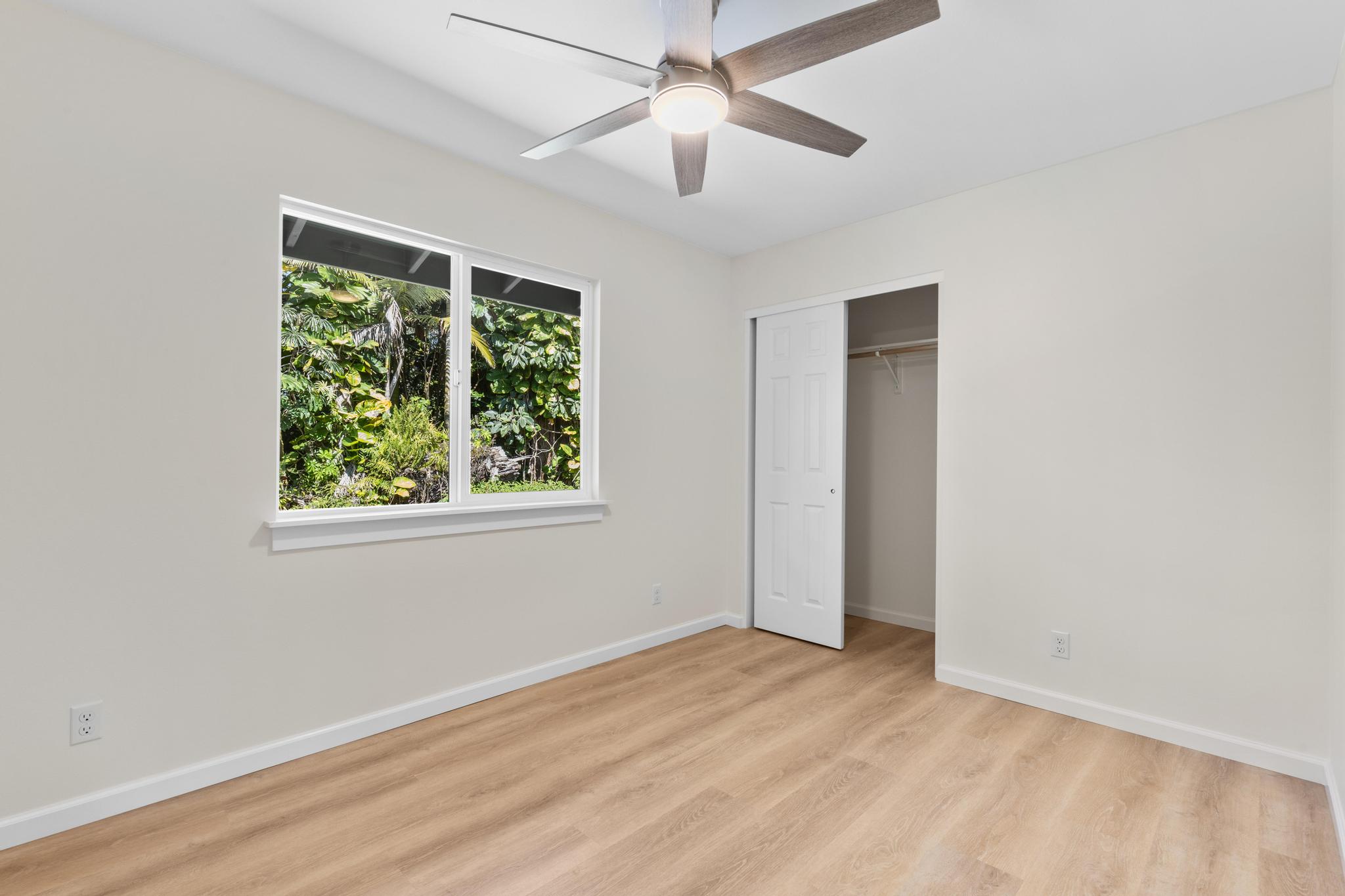 16-2579 Ainaloa Drive Pahoa, HI 96778 - Photo 15 of 30 wooden floor in an empty room with a window