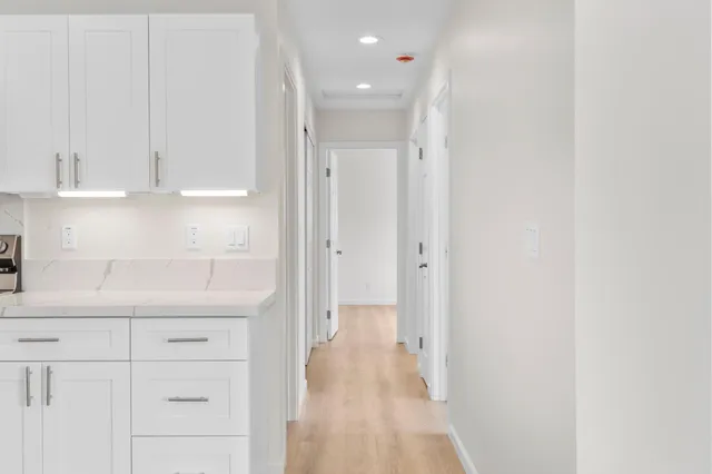 a kitchen with white cabinets and a sink