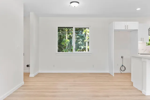 a view of a livingroom with wooden floor and a window