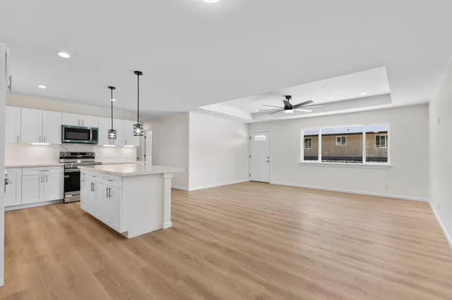 a kitchen with white cabinets and white appliances