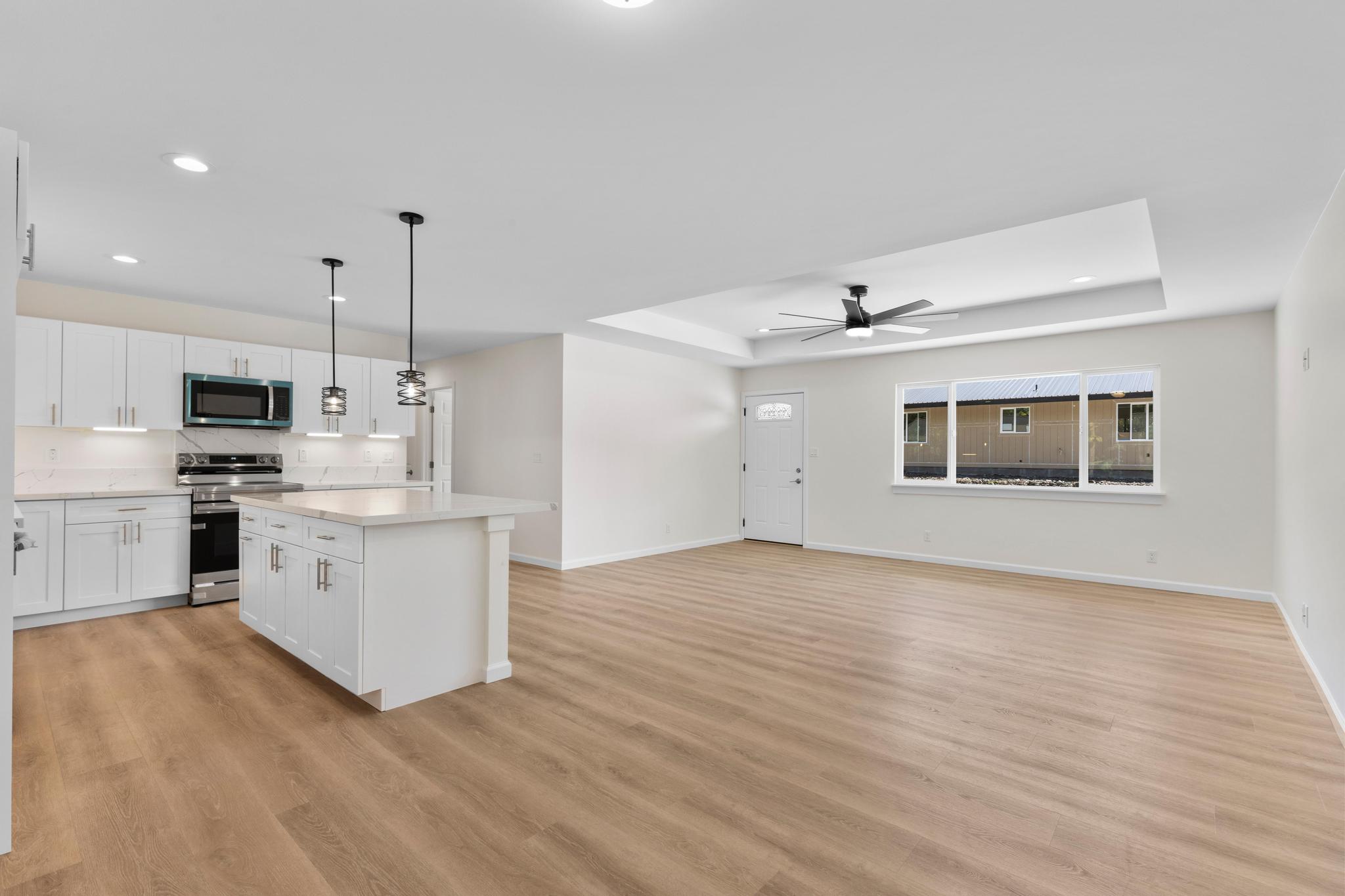 16-2579 Ainaloa Drive Pahoa, HI 96778 - Photo 20 of 30 a kitchen with white cabinets and white appliances